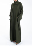 Woman wearing an olive green abaya on a white background